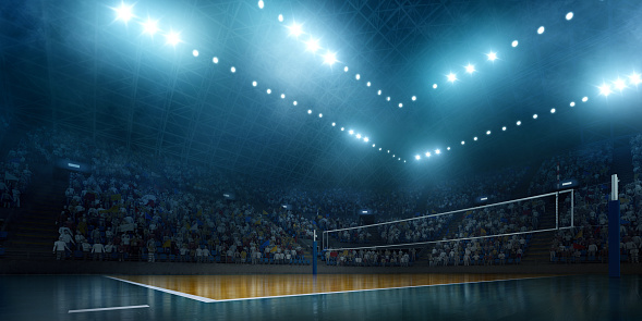 Panoramic view of indoor volleyball arena with crowd. There is a volleyball net in the left part of the image. Stadium seating stretches across the middle portion of the image, and the seats are filled with spectators. The image is fully made in 3D.