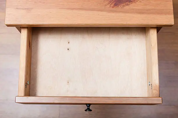 top view of empty open drawer of nightstand
