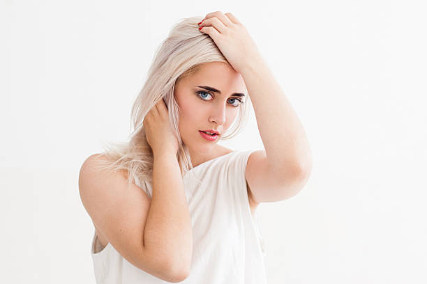 istock Frustrated young woman touching her head 592389754