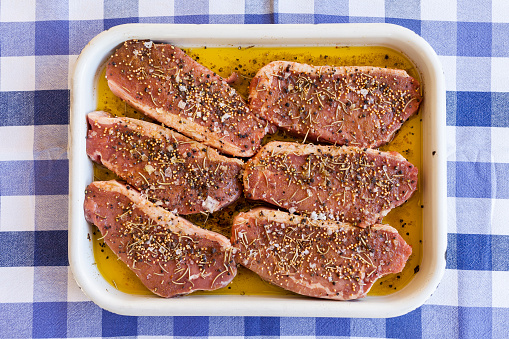 Beautiful steak pieces in marinade with spices.