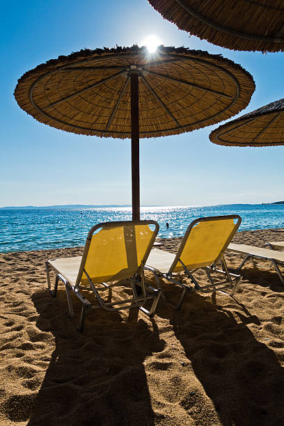istock Straw parasols on a beach in Sithonia 592390780