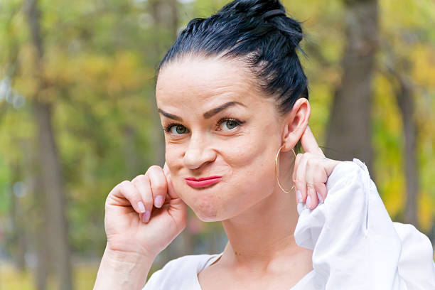 istock Funny brunette in autumn park 592391100