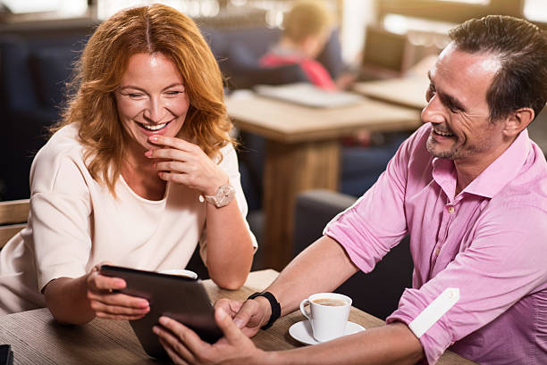 istock Man and woman using tablet together 592391190