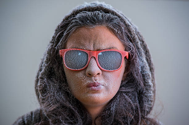 Pretty woman wearing winter outfit and sunglasses Pretty woman wearing winter outfit and sunglasses. Bemused expression on her face wonderingly stock pictures, royalty-free photos & images