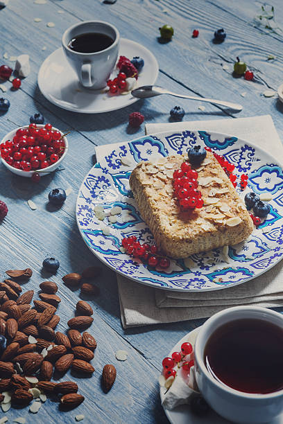 istock Pastry pie, tea, coffee and berries at blue rustic wood 592392332