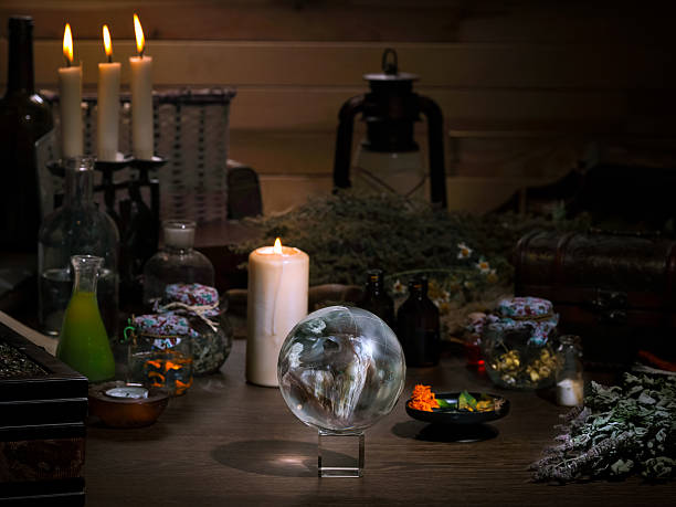 istock Mystical still life - the magic ball, candles, herbs. 592392578