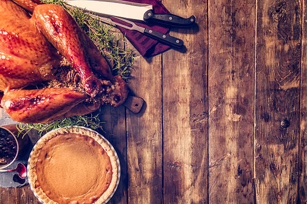 istock Stuffed Turkey and Pumpkin Pie Background 592394310