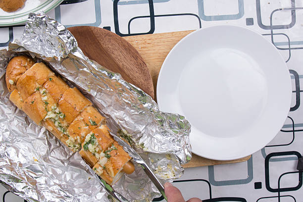 istock Chef put sausage bread to plate 592394744