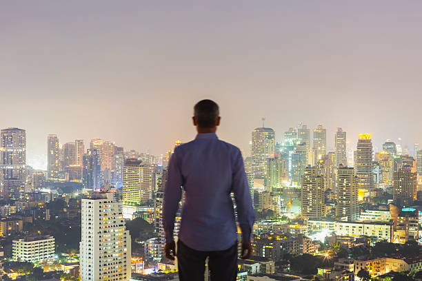 istock Man on the top of skyscraper 592394752