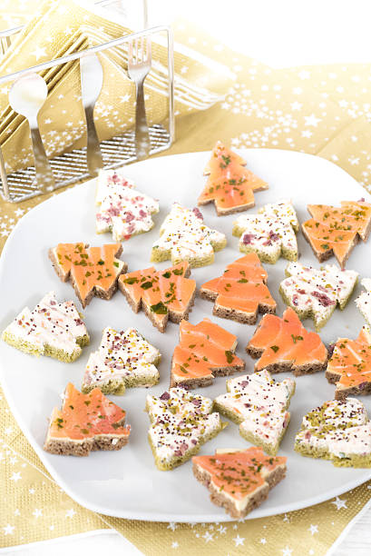Salmon and cream cheese Christmas tree open sandwiches stock photo