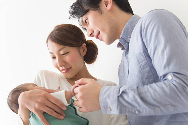 istock Japanese couple playing with baby 592396690