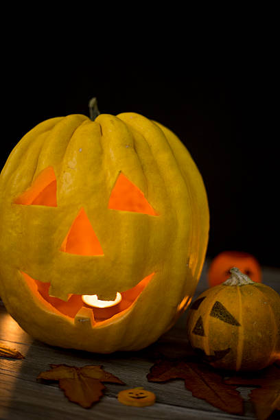 istock Halloween pumpkin head jack lantern on wooden background 592398796