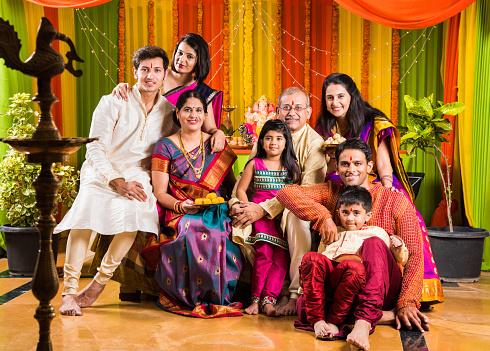 group photo of happy indian family in ganesh festival, happy indian family celebrating ganpati festival or ganesh utsav or ganesh festival