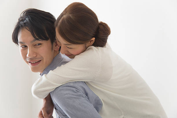 istock Japanese couple having a piggyback ride 592399888
