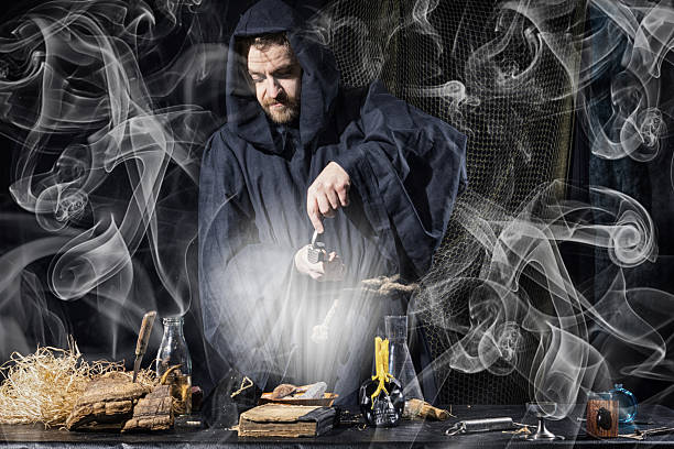 istock Portrait of a crazy medieval scientist working in his laboratory 592400074