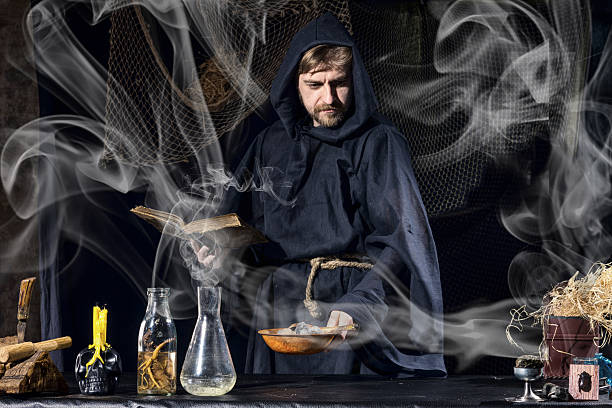 istock Halloween magician is preparing for  magical ritual in ancient table 592400524