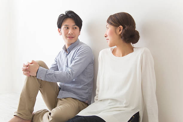 istock Japanese couple sitting looking at each other 592400932