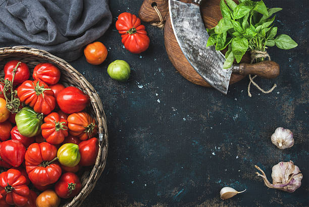 istock Fresh colorful ripe heirloom tomatoes in basket, copy space 592401720