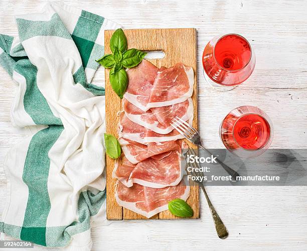 Prosciutto Di Parma Ham Slices And Rose Wine Glasses Stock Photo - Download Image Now