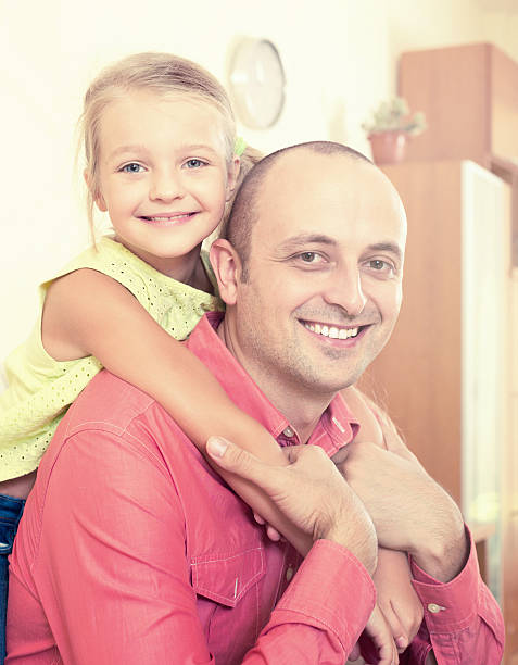 istock father and little daughter posing in domestic interior 592402638