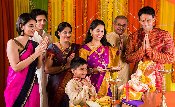 indian family doing ganesh puja or ganesha pujan