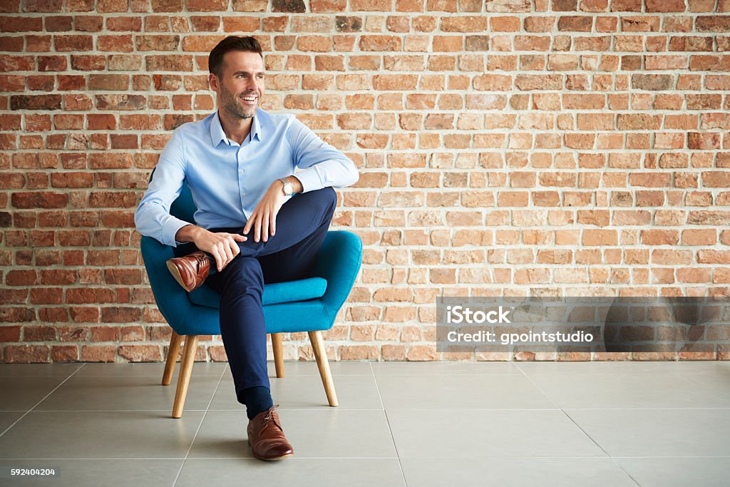 Businessman sitting in the armchair Men Stock Photo