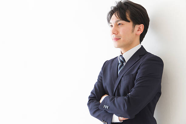 Japanese businessman with arms crossed Japanese businessman with arms crossed one mid adult man only stock pictures, royalty-free photos & images