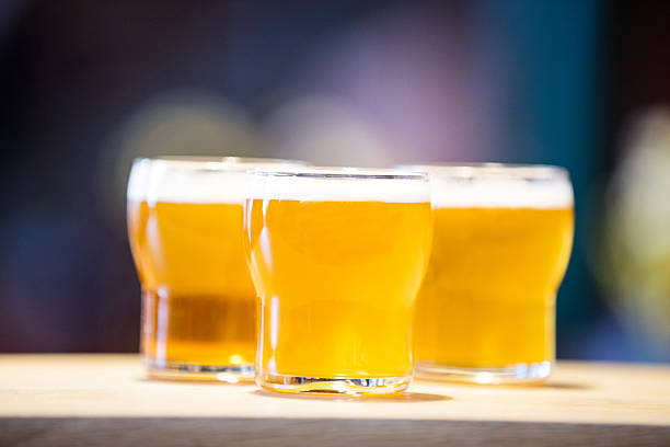istock Three beer glasses on the bar counter 592405152