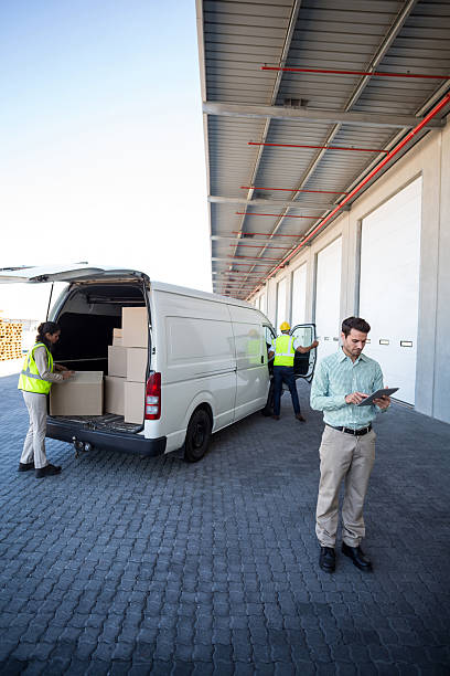 istock View of manager using tablet in front of workers 592405490