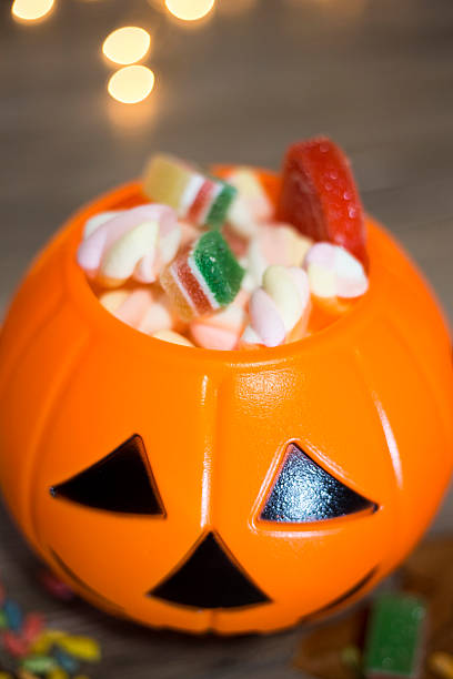 istock Halloween Jack o Lantern pail overflowing with candy 592406408