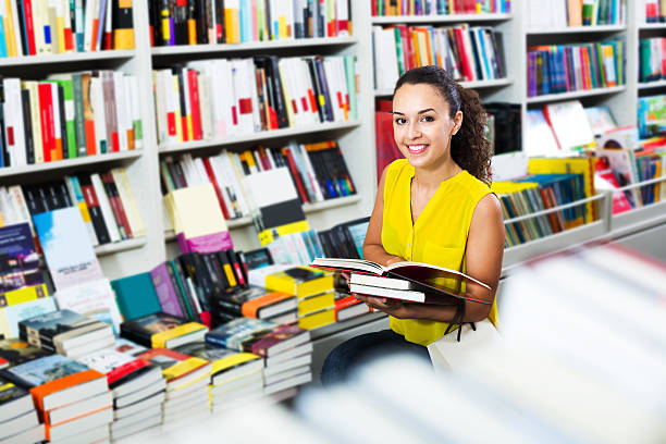 istock Woman reading textbook in shop 592406882