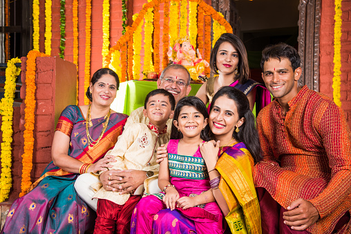 group photo of cheerful indian family in ganesh festival, happy indian family and ganpati festival