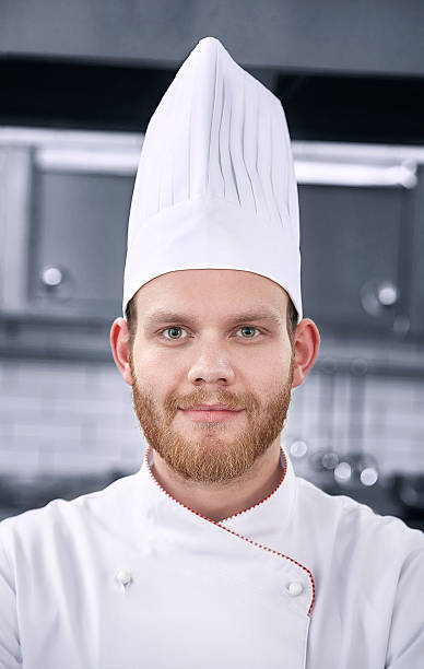 istock Male chef portrait in restaurant kitchen 592409234