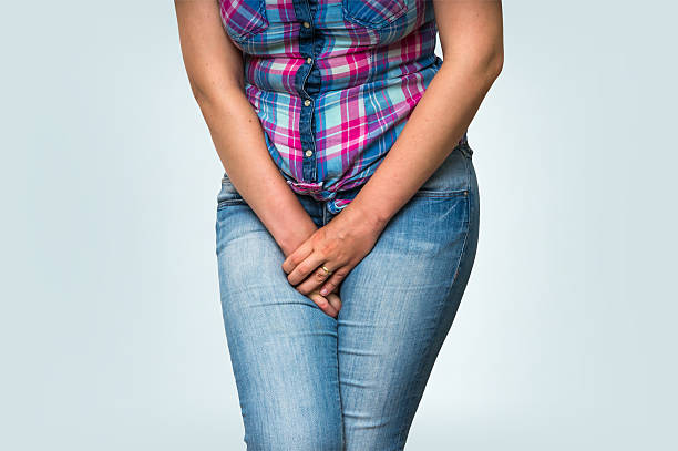 istock Woman with hands holding her crotch, she wants to pee 592409336