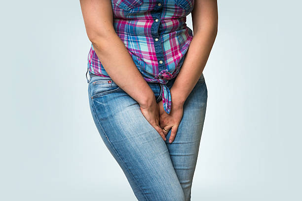Woman with hands holding her crotch, she wants to pee