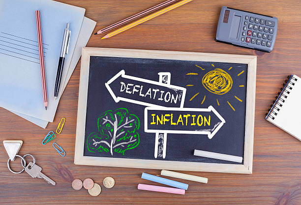 istock Deflation - Inflation signpost drawn on a blackboard 592643136