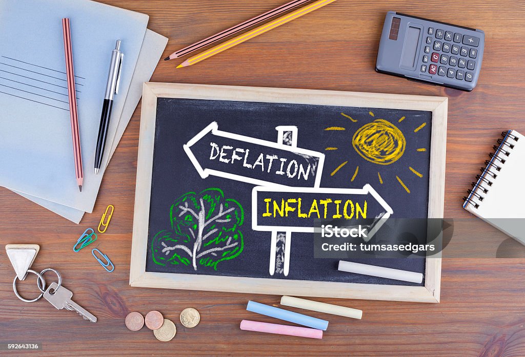 Deflation - Inflation signpost drawn on a blackboard Arrow Symbol Stock Photo