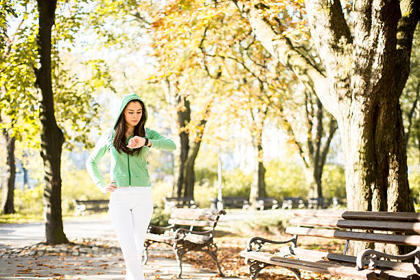 istock Young woman running in the park 592643366