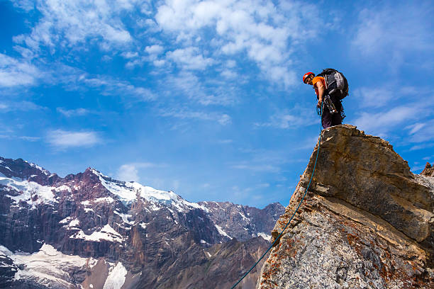 istock Alpine Climber staying on rocky Cliff 592643486