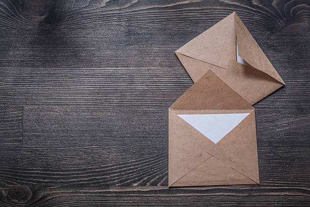 istock Vintage envelopes on wooden board copy space 592643742