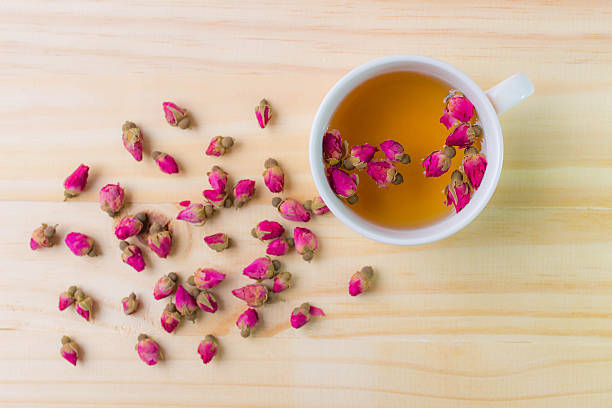 istock Cup of rose tea on wooden background,top view 592644106
