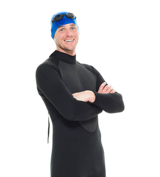 istock Smiling swimmer standing with arms crossed 592644400