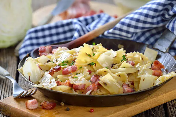 Pasta with fried white cabbage and bacon, an Austrian specialty called 'Krautfleckerl', served in an iron frying pan