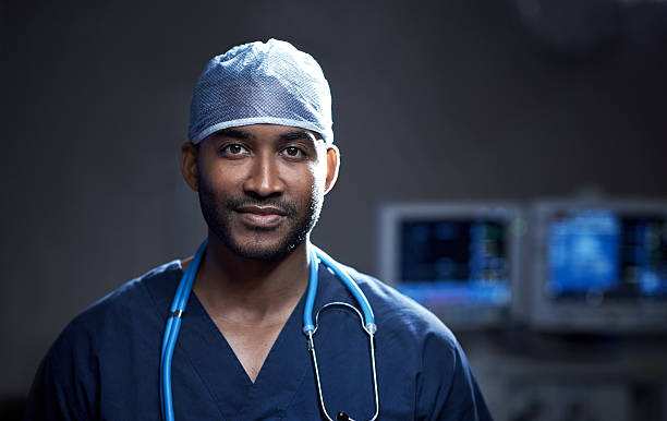 Skilled in saving lives Portrait of a confident young surgeon standing in an operating room operating room photos stock pictures, royalty-free photos & images