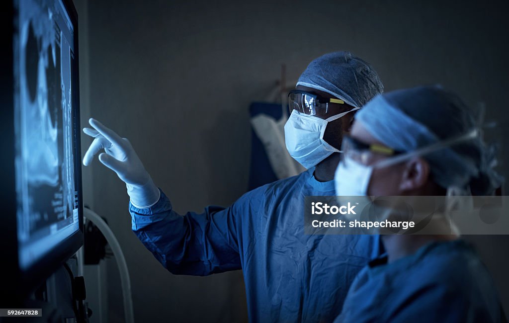 Surgical excellence at it’s best Shot of two surgeons analyzing a patient’s medical scans during surgery Doctor Stock Photo
