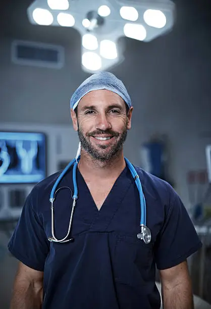 Portrait of a confident surgeon standing in an operating room