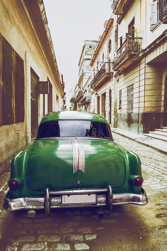 Old american park car on street in Havana,Cuba, vintage effect photo with retro toned background