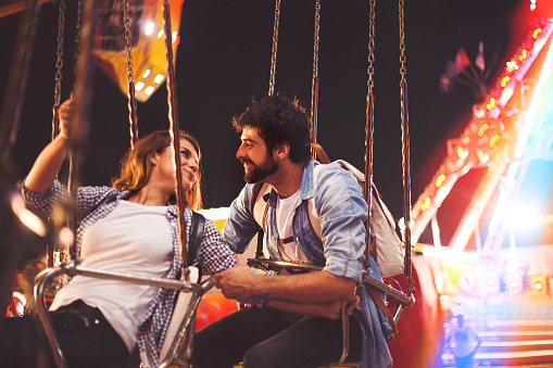 Young couple having fun at amusement park