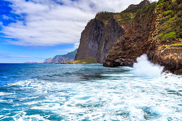 View of beautiful mountains and ocean on northern coast near Guindaste, Faial, Portugal
