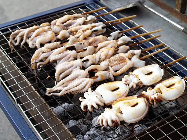 istock fresh squid barbecue grilled on charcoal stove 592651720